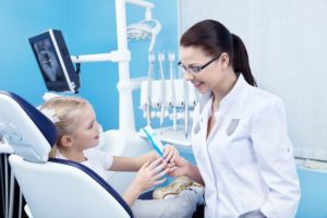 Dentist Speaking to Pediatric Patient