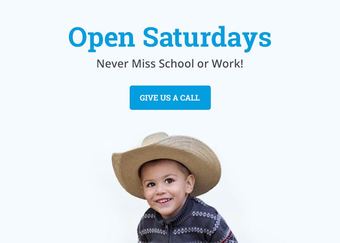 kid smiling in cowboy hat