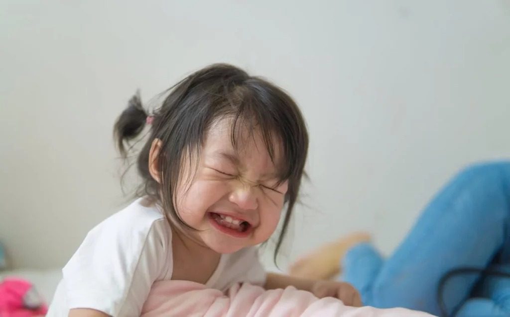 Toddler smiling with closed eyes