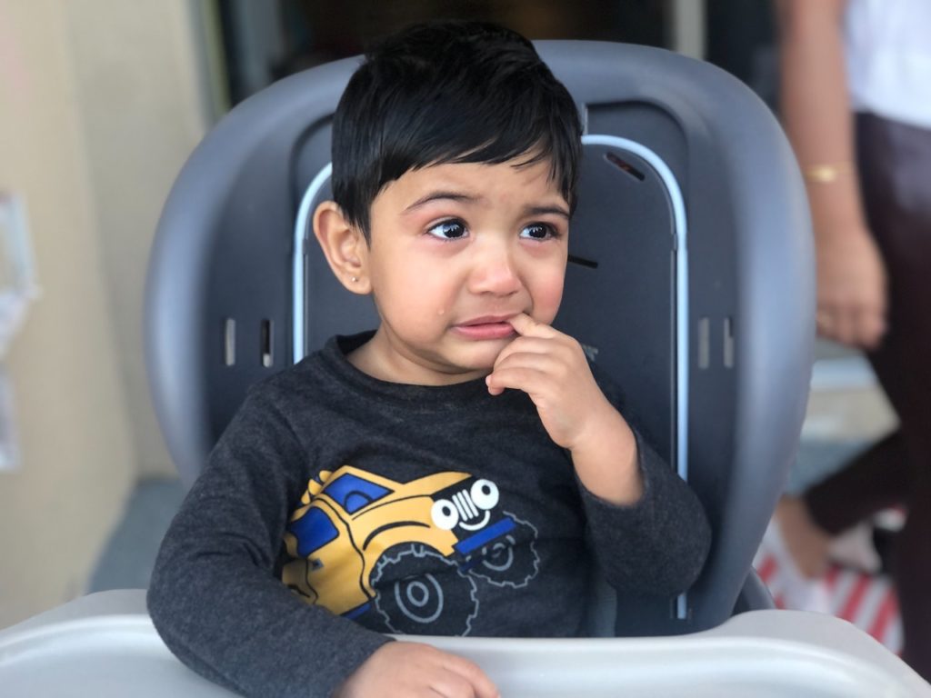 Child with toothache pointing to his tooth