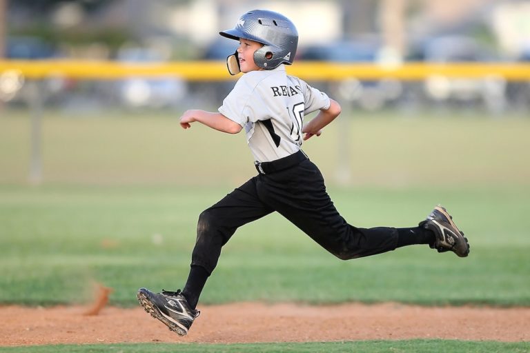 Youth baseball player running