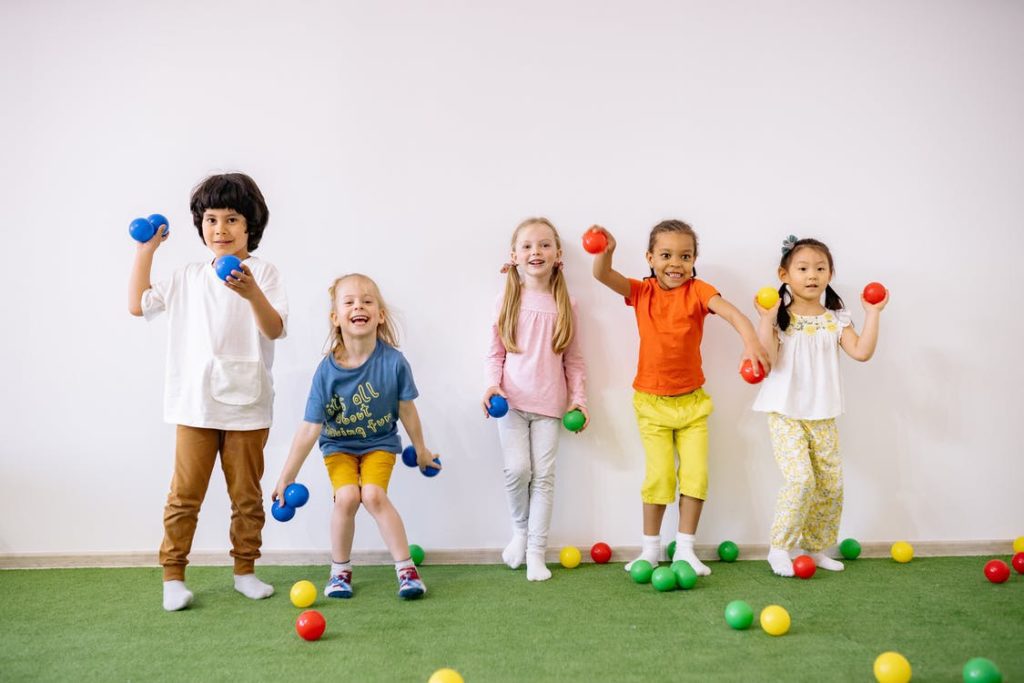 Children playing a game with plastic balls